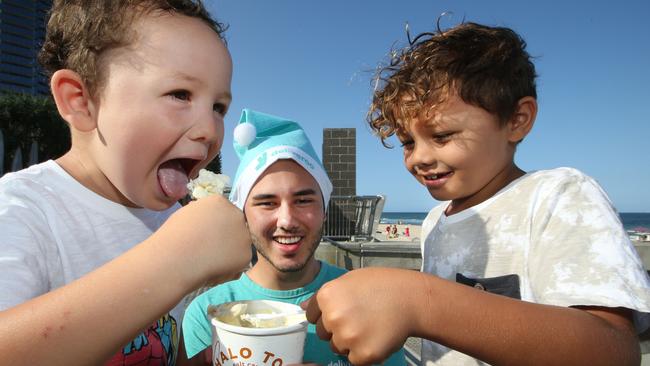 Jussie Montgomery, 3, Isaiah Ahsam, and Pippen Montgomery of Ashmore trying some of the giveaways. Picture: Glenn Hampson