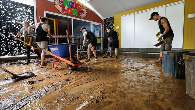 Ellis Beach Bar and Grill staff members scraped up inches of thick mud from the floor after debris caused by flooding rain tore through the popular beachside eatery late last year. Picture: Brendan Radke