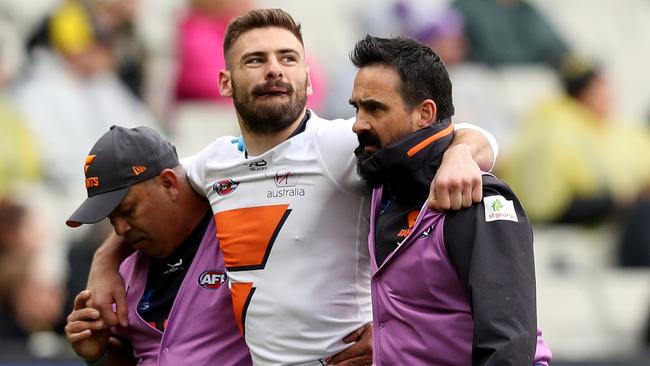 Stephen Coniglio is helped off the ground on Sunday. Picture: AAP