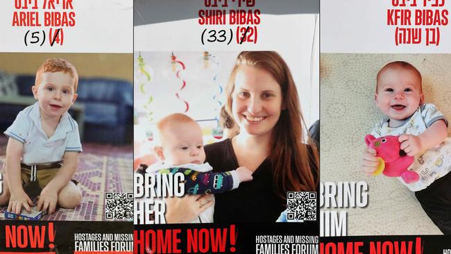 This combination of pictures created on February 20, 2025 shows posters bearing the portraits of Israeli hostages Shiri Bibas (C) and her two children Ariel (L) and Kfir (R), held in the Gaza Strip since the October 7, 2023. Picture: AFP