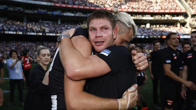 An emotional Taylor Adams of the Magpies hugs Darcy Moore. Photo by Daniel Pockett/AFL Photos/via Getty Images.