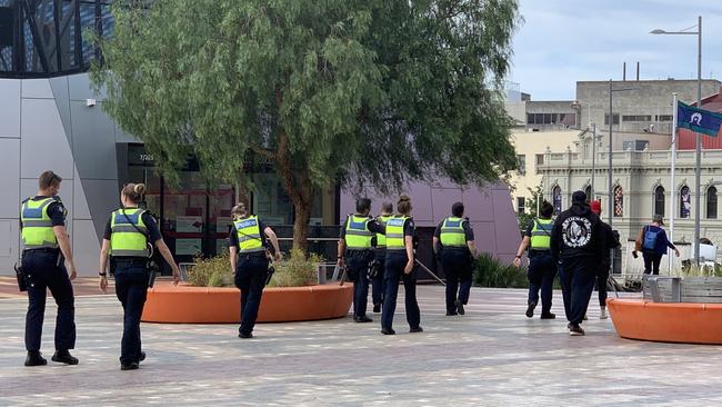 Police disperse a group of rival gangs at Harmony Square.