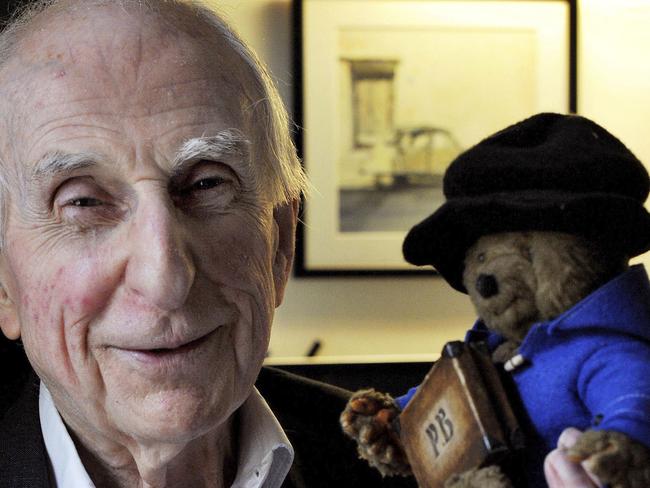 FILE - In this June 12, 2015 file photo, Michael Bond poses with a soft toy version of Paddington bear. Publisher HarperCollins says Michael Bond, creator of globe-trotting teddy Paddington bear, died on Tuesday June 27, 2017, aged 91. (Nick Ansell/PA via AP)