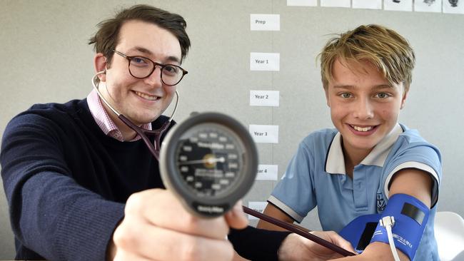 Researcher Jonathan Glenning takes the blood pressure of 12 year-old Christ Church Grammar School student Louis. Picture: Andrew Henshaw