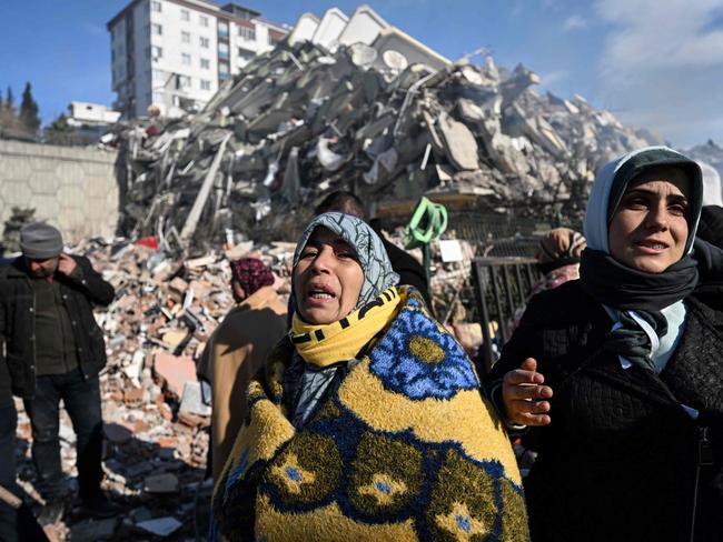 Women react as they wait for a rescue team next to their collapsed building in the southeastern Turkish city of Kahramanmaras. Picture: AFP