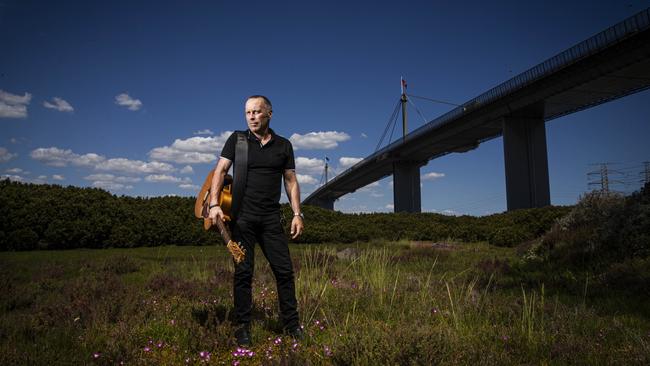 Mark Seymour under the West Gate Bridge, where 35 construction workers tragically lost their lives in a horrific 1970 accident. Picture: Aaron Francis