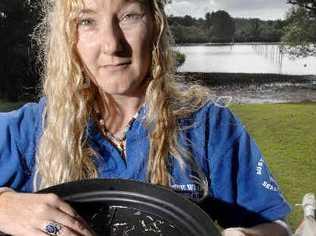 Kathrina Southwell, of Australian Seabird Rescue, sifts through the alarming amount of small plastic strips scooped up when they trawled a small section of the Richmond River at Ballina last week. . Picture: Jay Cronan