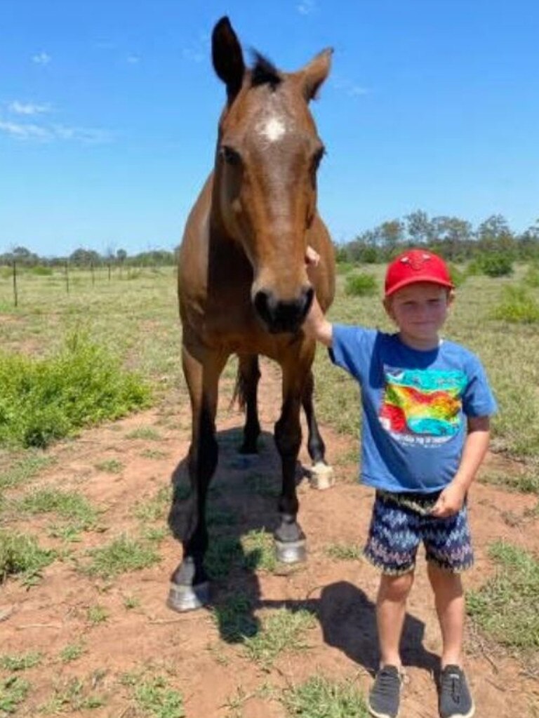 Brady Hunt, the son of Dragons star Ben Hunt, posing one of the horses his dad owns as part of his campdrafting and cutting business in Rockhampton. Credit: Supplied