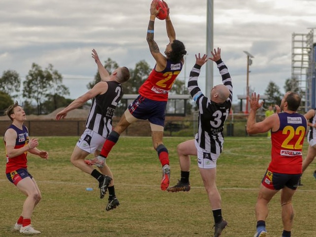 Andre Headberry flies high for Diggers Rest. Picture: Aaron Cook