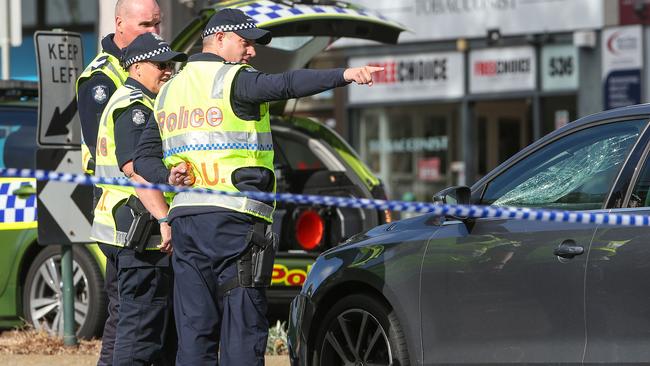 Police examine the car which hit the pedestrian. Picture: Ian Currie