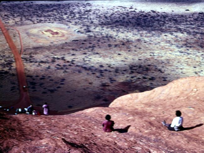 David Hewitt still has a collection of photographs taken during his time living and working in communities near Uluru. They include this photograph of two Aboriginal women sitting on the rock. Picture: David Hewitt