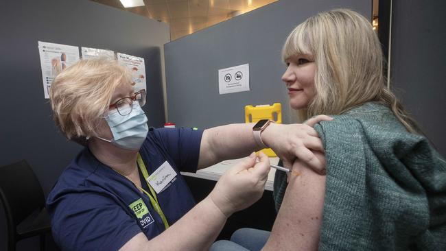 Chantelle Parrant of Kingston receives her second Pfizer vaccination from nurse Karina Skegg at the Moonah Vaccination Centre in Tasmania on Tuesday. Picture: Chris Kidd