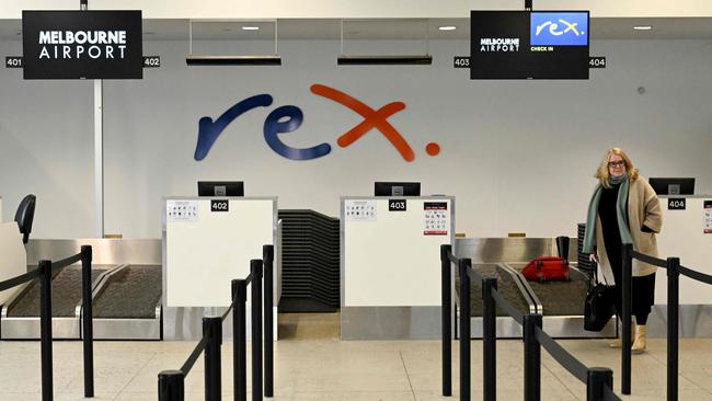 A passenger checks in for a Rex flight at Melbourne's Tullamarine Airport. Picture: William West AFP