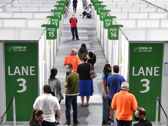 People queue up to receive the Pfizer Covid-19 vaccine at the vaccination hub at the Brisbane Entertainment Centre in Boondall. Picture: NCA NewsWire / Dan Peled