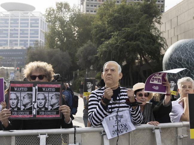 A protester dressed as Mr Netanyahu in a prisoner uniform demonstrates outside the court. Picture: Getty Images