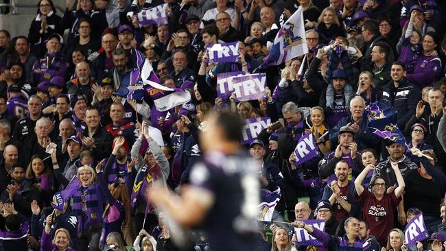 Storm fans celebrate a Billy Slater try against the Sharks at AAMI Park. Picture: AAP