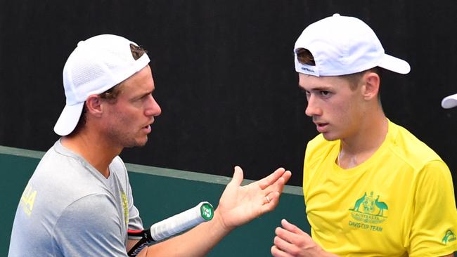 Australian Davis Cup captain Lleyton Hewitt talks to teenager Alex de Minaur at Pat Rafter Arena in Brisbane yesterday