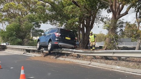 A medium sized SUV managed to mount a guardrail. Picture: Peter Schweinsberg