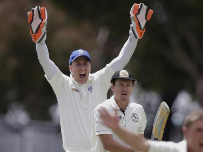 Michael Chaplin with the wicketkeeping gloves on.