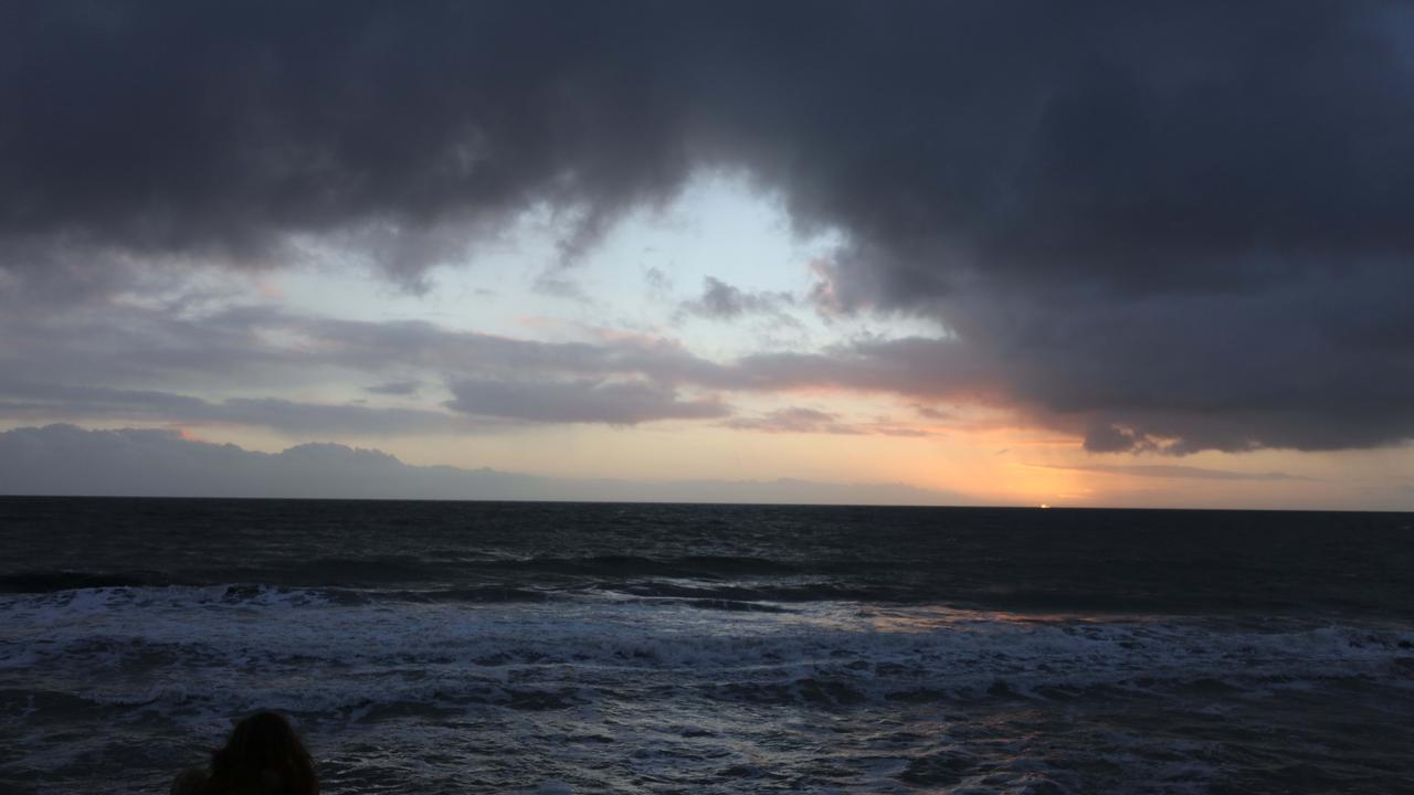 Winter weather along the Glenelg boardwalk as the sun goes down over the Spencer Gulf, South Australia. Picture: Emma Brasier
