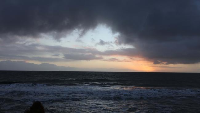 Winter weather along the Glenelg boardwalk as the sun goes down over the Spencer Gulf, South Australia. Picture: Emma Brasier