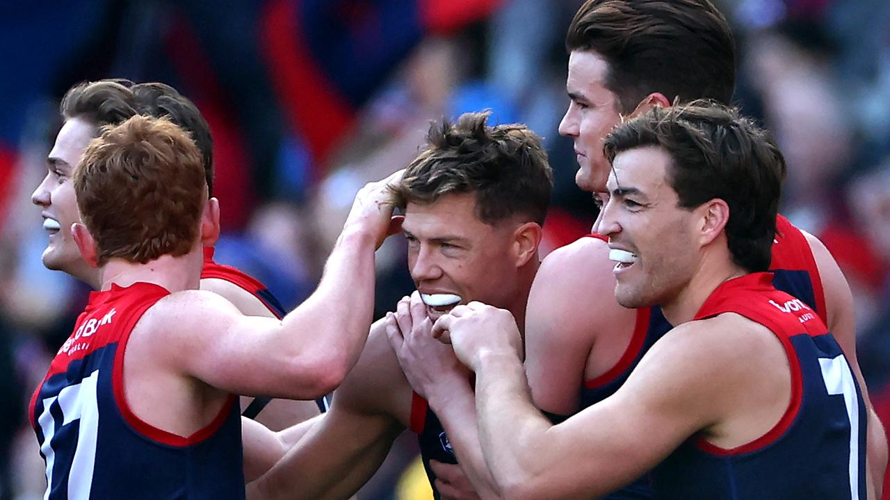 MELBOURNE, AUSTRALIA - JULY 07: Jake Melksham of the Demons is congratulated by team mates after kicking a goal during the round 17 AFL match between Melbourne Demons and West Coast Eagles at Melbourne Cricket Ground, on July 07, 2024, in Melbourne, Australia. (Photo by Quinn Rooney/Getty Images)