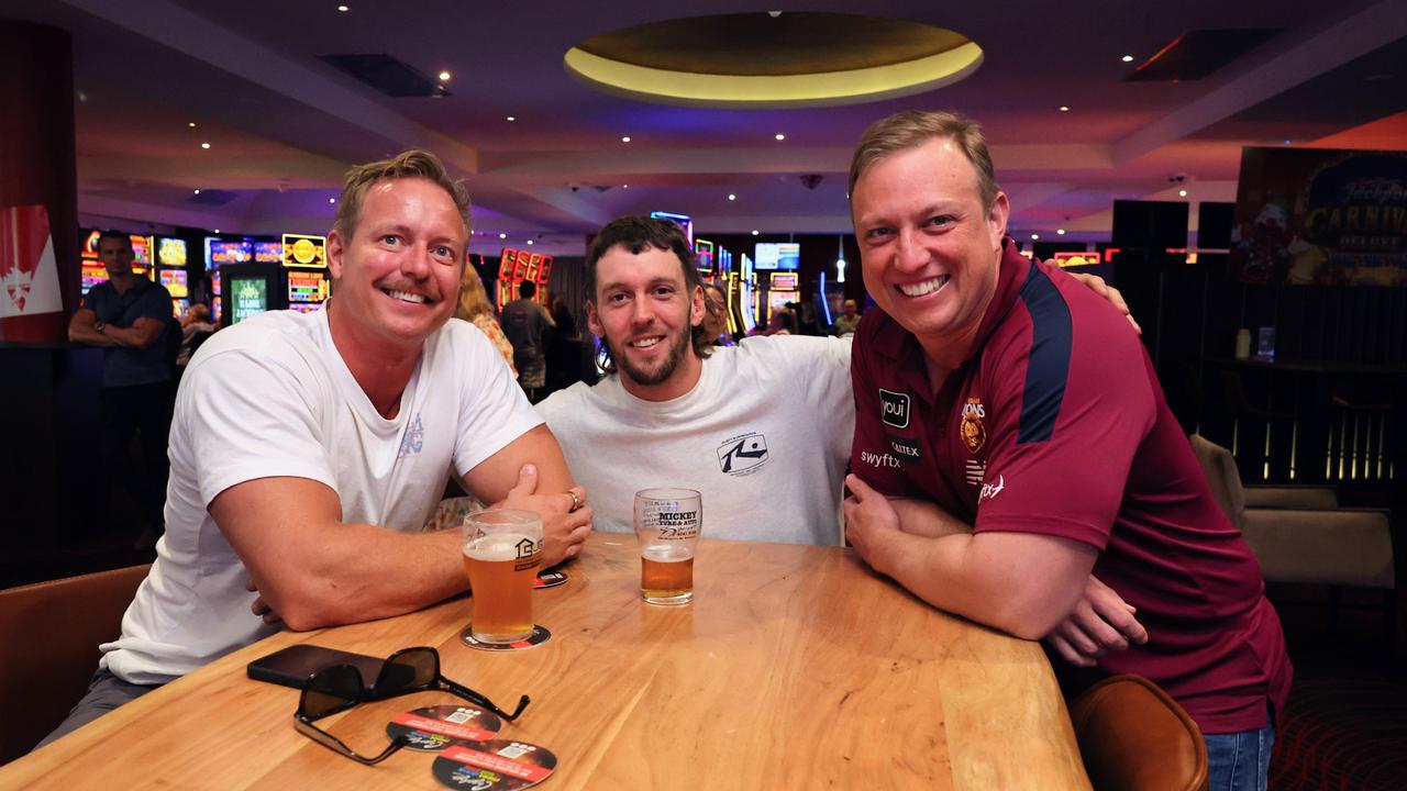 Queensland Premier Steven Miles has a yarn with Cairns locals Nelson Reinaldo and Liam Murphy at Cazalys Sports Club during half time in the 2024 AFL grand final match between the Brisbane Lions and the Sydney Swans. Picture: Brendan Radke