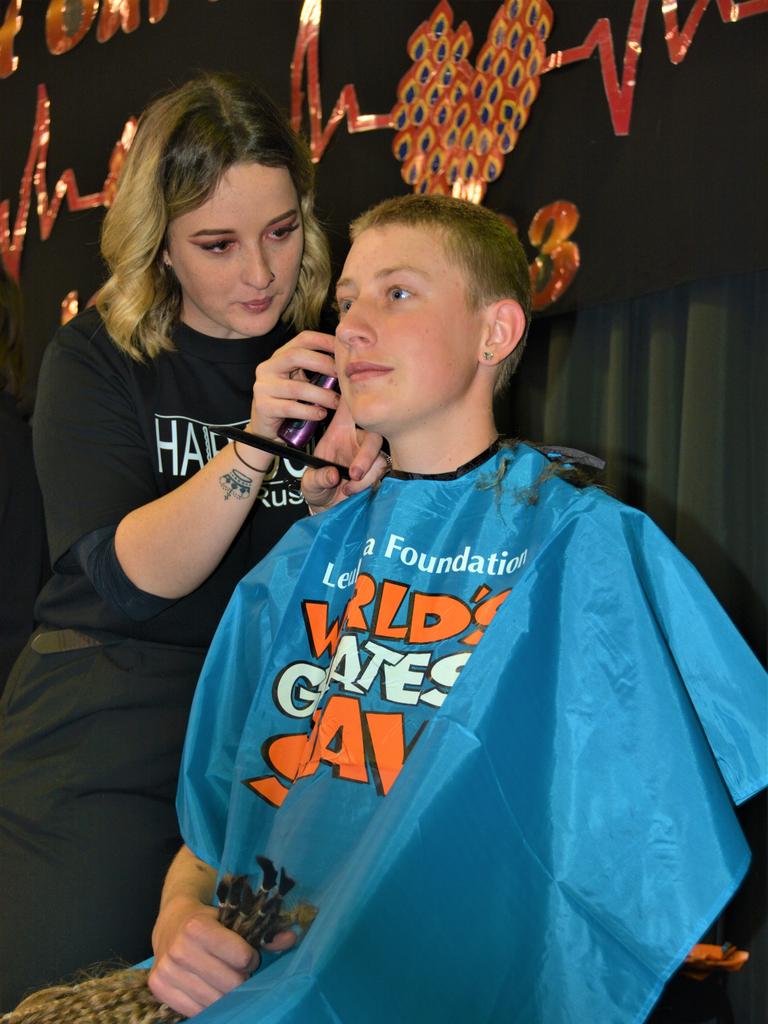 At the St Joseph's College 2023 World's Greatest Shave event is student Emily Chandler getting her hair cut by her support crew and hairdresser Natalie Schmidt from the Hair Room on Russell. Picture: Rhylea Millar