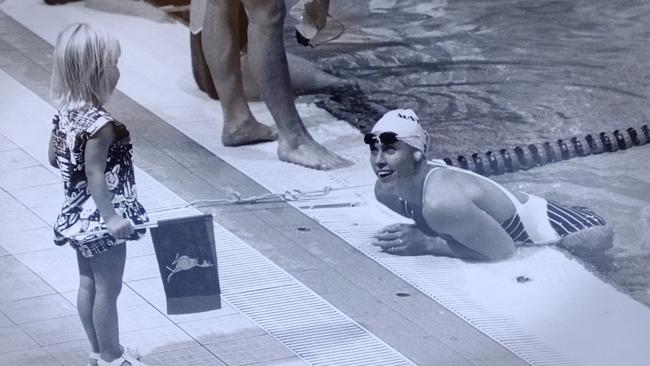 Jaimi Kenny watches her mum Lisa from the sidelines of the Olympic swimming pool in 1990. Picture: Jim Fenwick