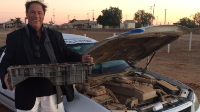 Sump thing is wrong. John Connolly with the ute's busted sump in Marree.