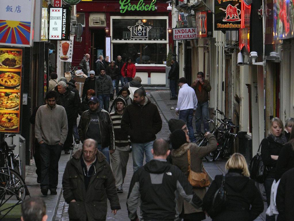 Tourists walk in De Wallen, Amsterdam's Red Light district. Picture: Ap