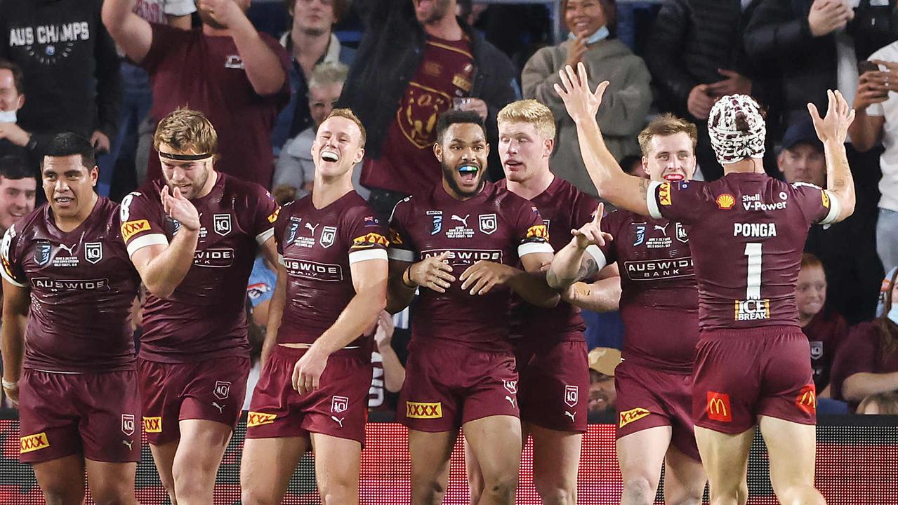 Queensland players revel in one of Ben Hunt’s two tries.