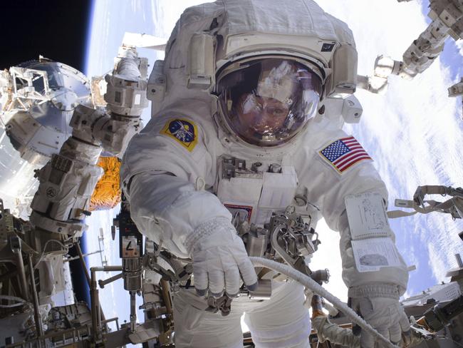 In this Jan. 6, 2017 made available by NASA, astronaut Peggy Whitson works during a spacewalk outside the International Space Station. Whitson and fellow astronaut Shane Kimbrough successfully installed three new adapter plates and hooked up electrical connections for three of the six new lithium-ion batteries on the ISS. (NASA via AP)