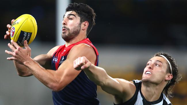 Christian Petracca marks against Collingwood’s Darcy Moore. Picture: Jono Searle/Getty