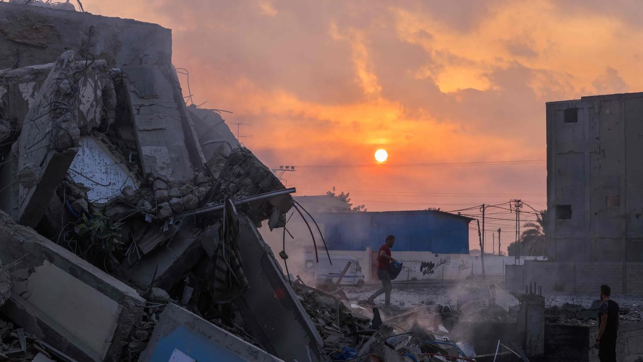 People inspect a building destroyed in Israeli strikes in Gaza City. Picture: AFP