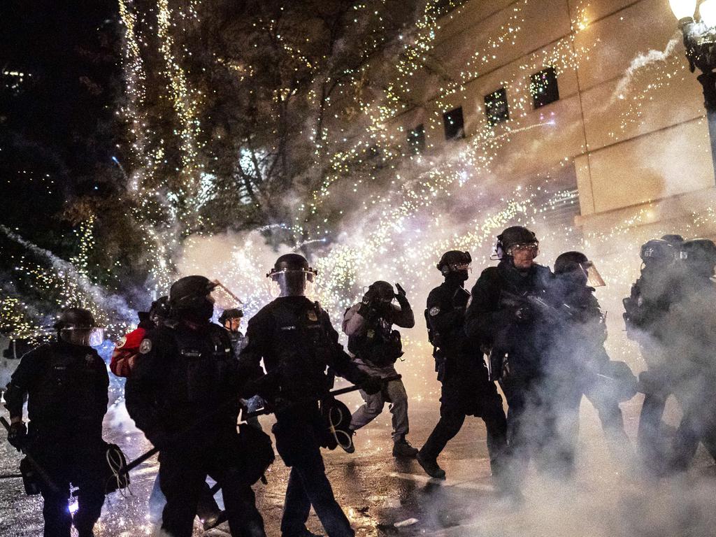 Portland police reacting to a firecracker in September protests. Picture: Nathan Howard/Getty Images/AFP