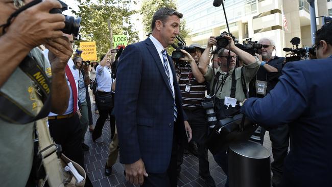 U.S. Rep. Duncan Hunter, center, leaves an arraignment hearing Thursday, Aug. 23, 2018, in San Diego. Hunter and his wife Margaret pleaded not guilty Thursday to charges they illegally used his campaign account for personal expenses. (AP Photo/Denis Poroy)