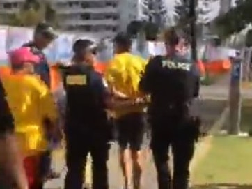 Dylan Voller is arrested and removed in handcuffs by police in Broadbeach, Gold Coast.