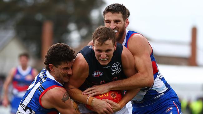 Jordan Dawson of the Crows is tackled at Mars Stadium in Ballarat. Picture: Graham Denholm