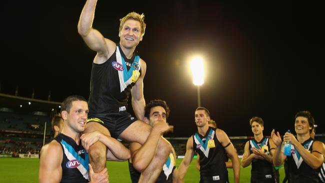 Kane Cornes of the Power is carried off by his teammates after playing his 250th match. Picture: Robert Cianflone/Getty Images.