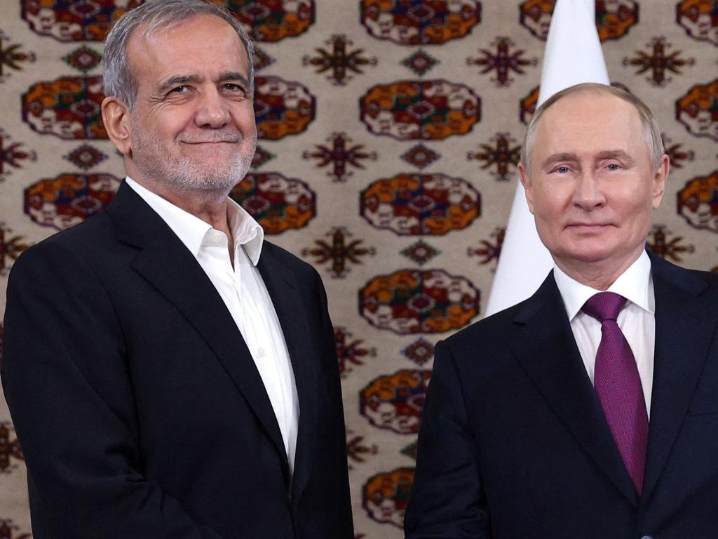 In this pool photograph distributed by the Russian state agency Sputnik, Russia's President Vladimir Putin meets with Iran's President Masoud Pezeshkian on the sidelines of an international forum "Interrelation of times and civilizations - basis of peace and development" dedicated to the 300th anniversary of poet Magtymguly Fragi's birthday in Ashgabat on October 11, 2024. (Photo by Alexander SHCHERBAK / POOL / AFP)