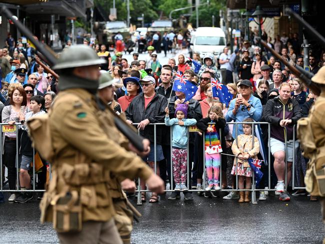 Crowds watch as men in WWI army uniform march during an Anzac Day parade in Brisbane. Picture: Dan Peled/Getty Images