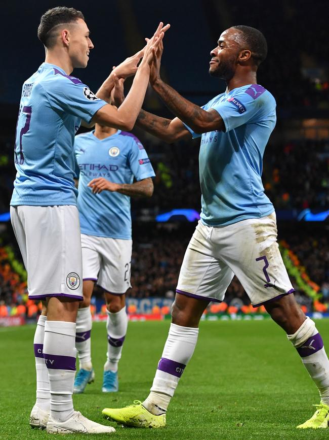 Manchester City stars Phil Foden (left) and Raheem Sterling celebrate a goal against Dinamo Zagreb. Picture: AFP