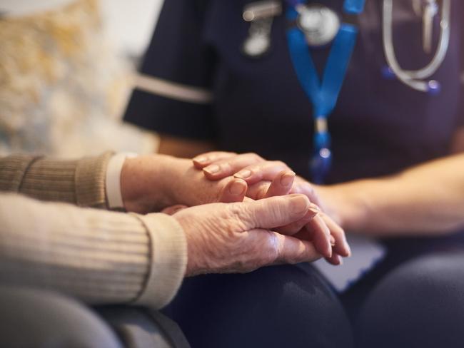 BAD AGED CARE:   A female nurse consoles a senior patient at home, aged care generic