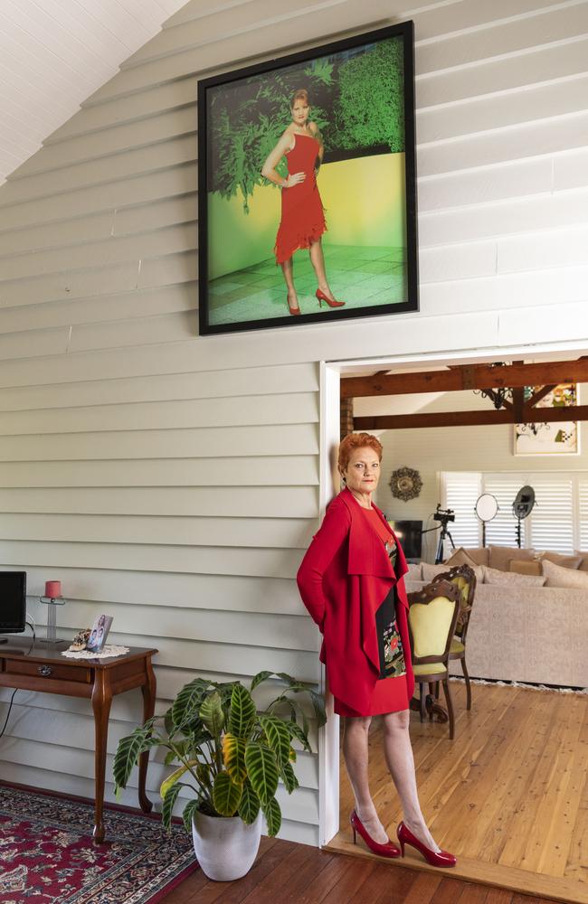 In the red: Senator Hanson at home with a photograph on the wall from around the time she came runner-up in the 2004 series of Dancing with the Stars. Picture: Mark Cranitch.