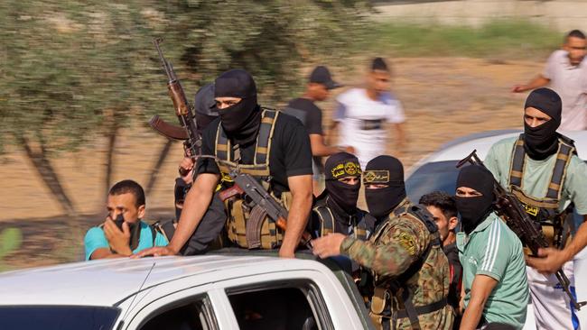 Palestinian militants move towards the border fence with Israel from Khan Yunis in the southern Gaza Strip. Picture: Said Khatib/AFP