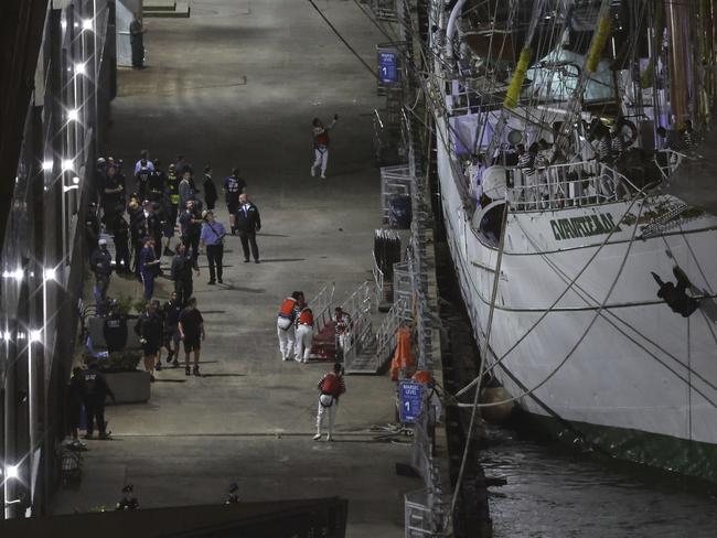 Sailors disembark at Pier 35 after the ship collided with the Brooklyn Bridge and reached dockside. AP Photo/Yuki Iwamura