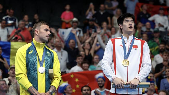 NANTERRE, FRANCE - JULY 31: Silver Medalist Kyle Chalmers of Team Australia and Gold Medalist Zhanle Pan of Team People's Republic of China stand on the podium during the Swimming medal ceremony after the Men's 100m Freestyle Final on day five of the Olympic Games Paris 2024 at Paris La Defense Arena on July 31, 2024 in Nanterre, France. (Photo by Quinn Rooney/Getty Images)