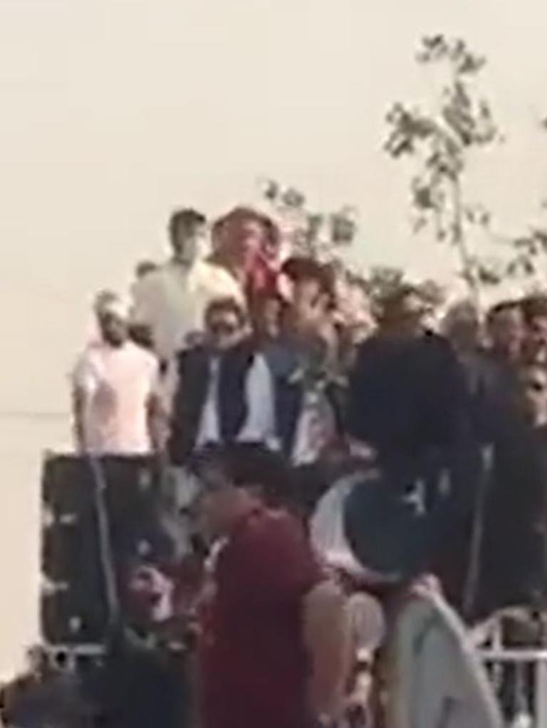 Imran Khan (in sunglasses) seconds before the attack.