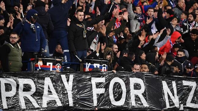 A banner reading "Pray for NZ" is displayed during the a football match in Paris. Picture; AFP.